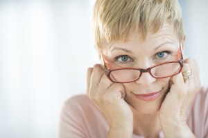 Older woman peering over her glasses