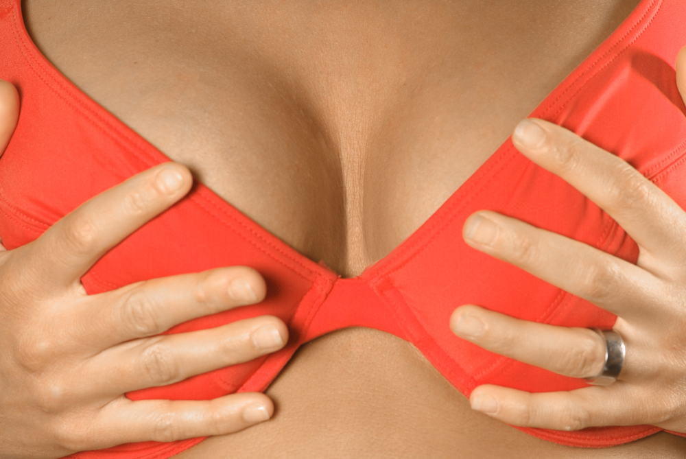 woman squeezing breast implants