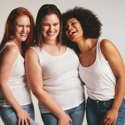 Diverse group of women laughing together.