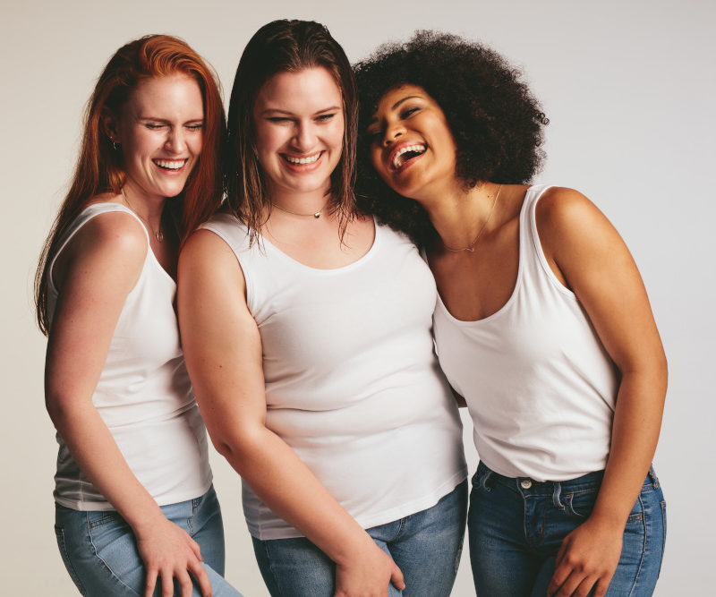 Diverse group of women laughing together.