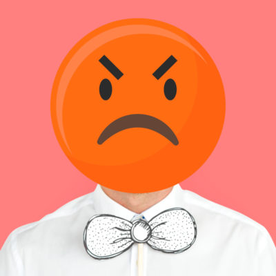 Person in white button down shirt and white bowtie wearing an angry emoji face.